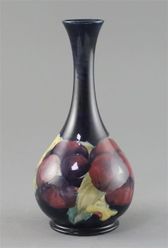 A Moorcroft pansy bottle vase, c.1917, H.21.7cm, professionally restored
